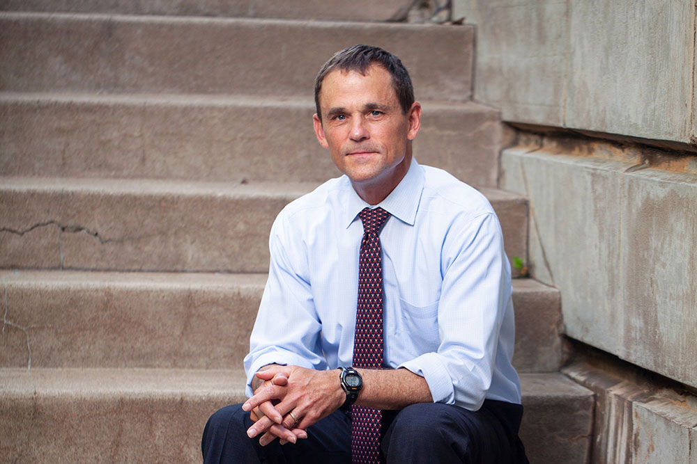 UVA President James E. Ryan sitting on steps looking at the camera